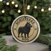 A round ornament featuring a black dog, with the text "SCHIPPERKE DOG" around the edge.