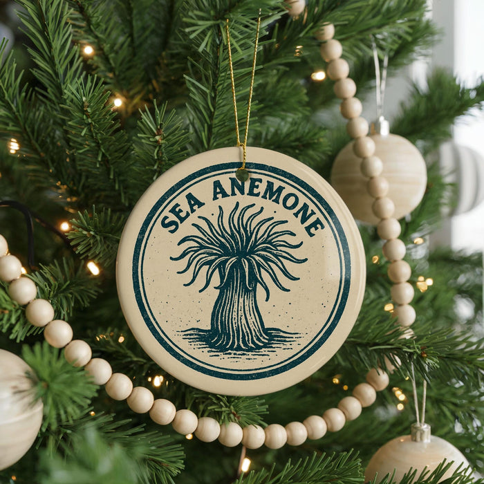 A Christmas tree decorated with ornaments, including a circular ornament with the text "SEA ANEMONE" and a beaded ornament.
