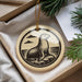 A decorative ornament featuring a seal sitting on a rock, with a cloudy sky in the background.