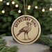 A round ornament with the text "SECRETARY BIRD" and an illustration of a bird standing on one leg.