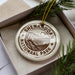 A circular ornament with the text "Shenandoah National Park" printed on it, surrounded by pine branches and pine needles.