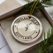 A circular ornament with the text "SHETLAND ISLANDS SCOTLAND" printed on it, surrounded by pine branches.
