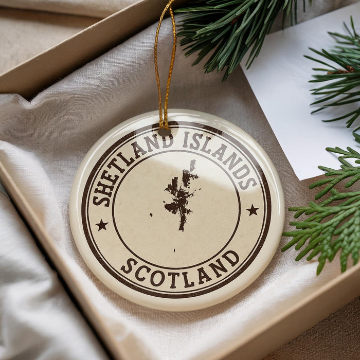 A circular ornament with the text "SHETLAND ISLANDS SCOTLAND" printed on it, surrounded by pine branches.