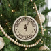 A Christmas tree decorated with ornaments, including a circular ornament with the text "SHETLAND ISLANDS SCOTLAND" printed on it.