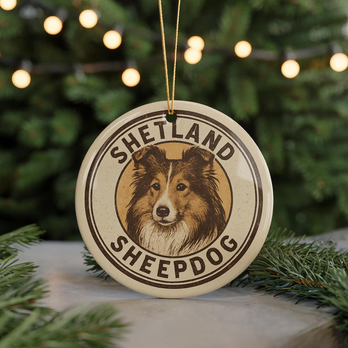 A circular ornament featuring a Shetland Sheepdog, with the text "Shetland Sheepdog" prominently displayed.