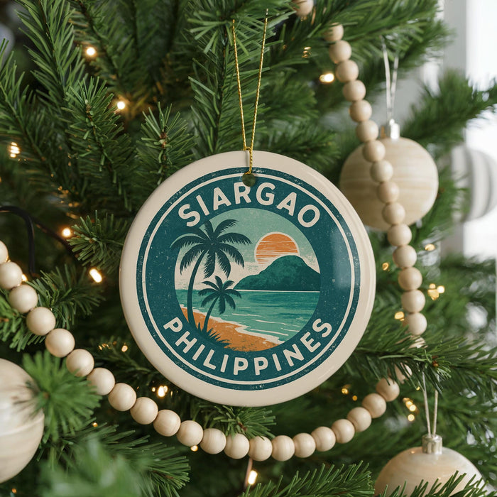 A round ornament on a Christmas tree with the text "SIARGAO PHILIPPINES" and a tropical beach scene.