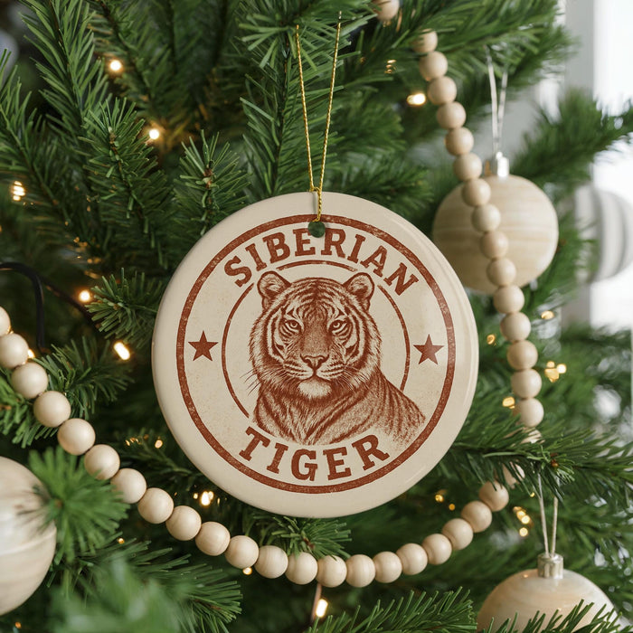 A Christmas tree decorated with ornaments, including a large circular ornament with a tiger image and the text "SIBERIAN TIGER" printed on it.