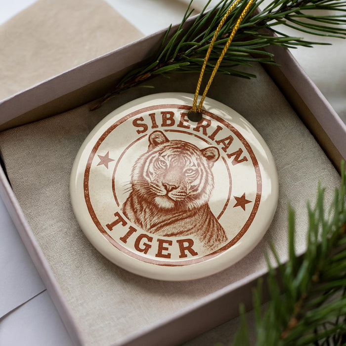 A ceramic ornament in a box, featuring a close-up image of a tiger's face.