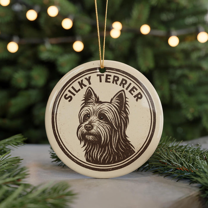 A round ornament featuring a silhouette of a Yorkie Terrier dog, with the text "Silky Terrier" written around the dog's head.