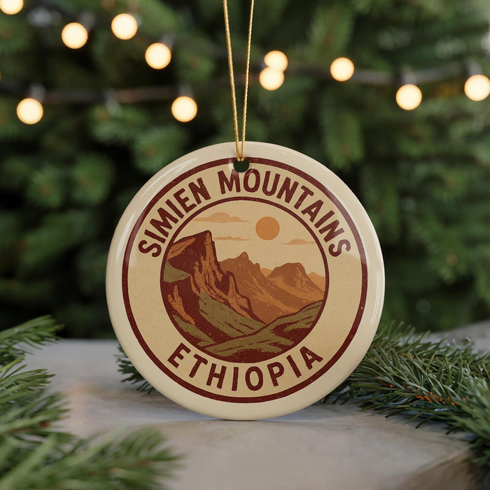 A circular ornament with the text "SIMIEN MOUNTAINS ETHiopia" and an illustration of mountains and a sun.