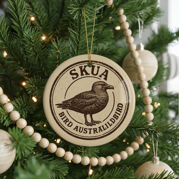 A Christmas tree decorated with ornaments, including a circular ornament with a bird image and the text "SKUA BIRD AUSTRALIHLBIRD".