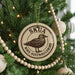 A Christmas tree decorated with ornaments, including a circular ornament with a bird image and the text "SKUA BIRD AUSTRALIHLBIRD".
