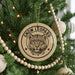 A Christmas tree decorated with ornaments, including a large circular ornament with a leopard's face and the text "SNOW LEOPARD" printed on it.