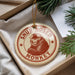A round ornament with a monkey image and the text "SNUB-NOSED MONKEY" printed on it, hanging from a string.