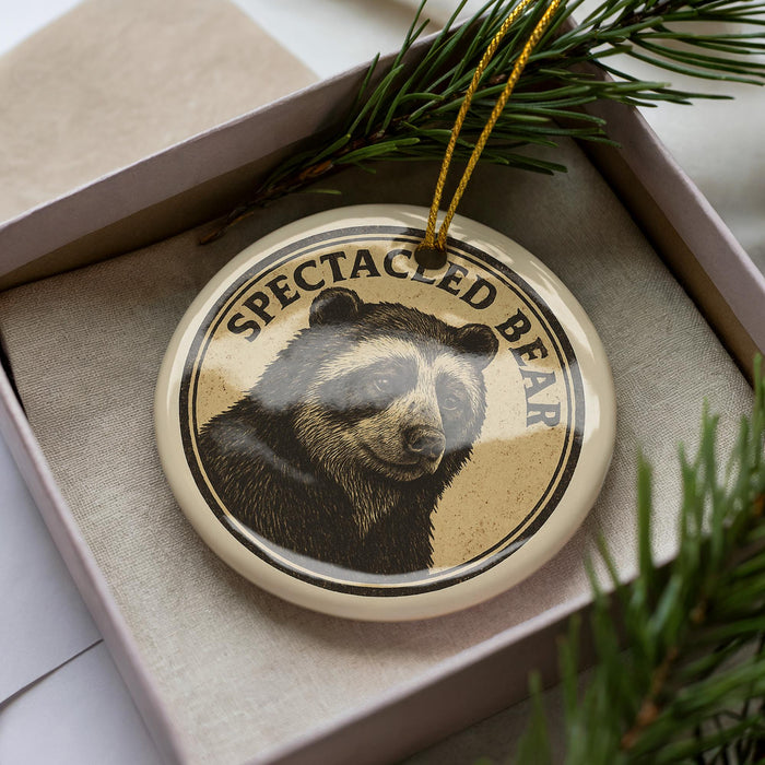 A decorative ornament featuring a close-up image of a bear's face, with the text "SPECTACED BEAR" around the image.
