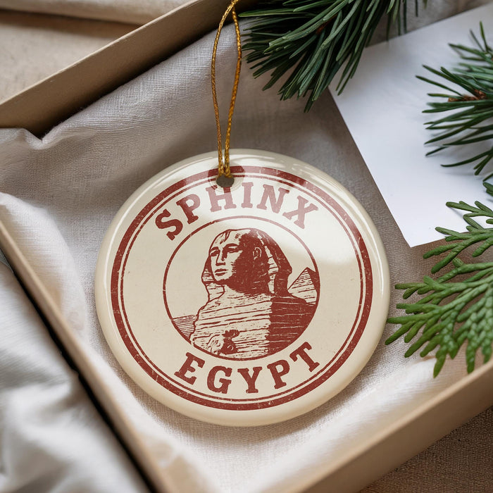 A round ornament with the text "SPHINX EGYPT" printed on it, featuring an illustration of the ancient Egyptian pharaoh.