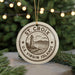 A circular ornament with the text "ST. CROIX U.S. Virgin Islands" printed on it, featuring a lighthouse and a coastal landscape.