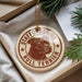 A circular ornament with a bull terrier image and the text "STAFFORDSHIRE BULL TERRIER" printed on it, hanging from a string.