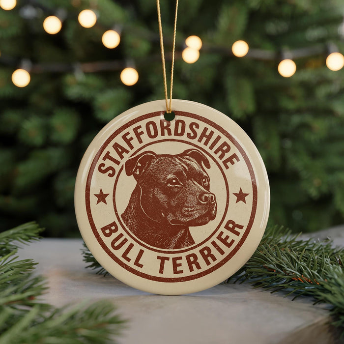 A circular ornament featuring a bull terrier dog's head, with the text "STAFFORDSHIRE BULL TERRIER" printed on it.