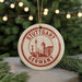 A circular ornament with the text "STUTTGART GERMANY" and an illustration of Stuttgart, Germany, is displayed in front of a Christmas tree with twinkling lights.