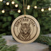 A round ornament with a tiger image and the text "SUMATRAN TIGER" printed on it, hanging from a string.