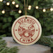 A round ornament with the text "SUZHOU CHINA" and an illustration of a bridge is displayed on a Christmas tree.