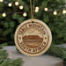 A circular ornament with the text "TABLE MOUNTAIN SOUTH AFRICA" printed on it, hanging from a string.