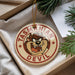A circular ornament with a cartoon image of a Tasmanian Devil character and the text "TASMANIAN DEVIL" printed on it.