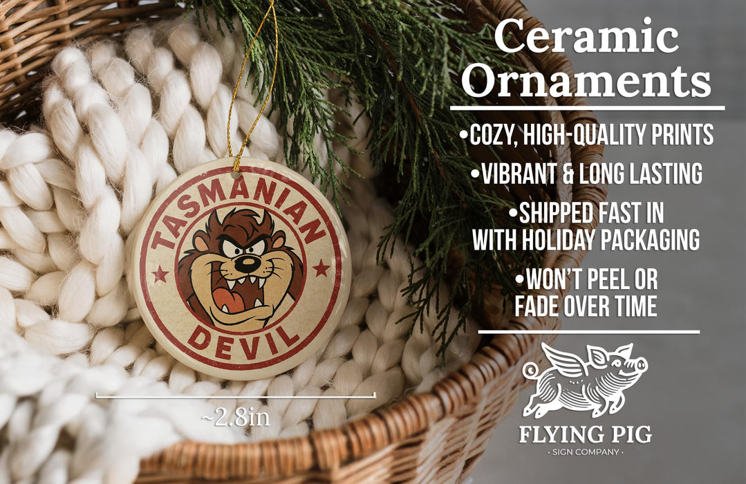Ceramic ornaments featuring a cartoon devil character, with text describing the ornaments as "cozy, high-quality prints, vibrant and long lasting, shipped fast in with holiday packaging, won't peel or fade over time".