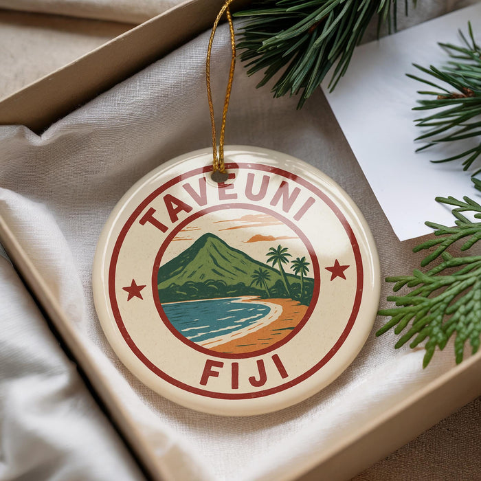 A round ornament with a tropical island design and the text "TAVEUNI Fiji" is displayed in a box with pine branches.