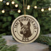 A circular ornament featuring a dog's head and the text "THAI RIDGEBACK DOG" is displayed in front of a blurred Christmas tree.
