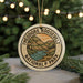 A circular ornament with the text "THEODORE ROOSEVELT NATIONAL PARK USA" and an illustration of a mountain landscape.