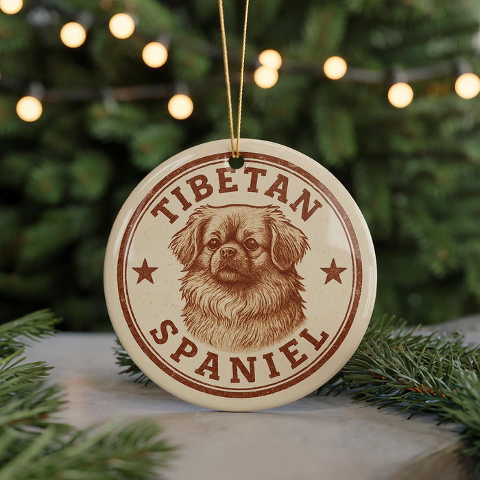 A circular ornament featuring a Tibetan Spaniel dog's head, with the text "TIBETAN SPANIEL" printed on it.