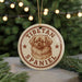 A circular ornament featuring a Tibetan Spaniel dog's head, with the text "TIBETAN SPANIEL" printed on it.