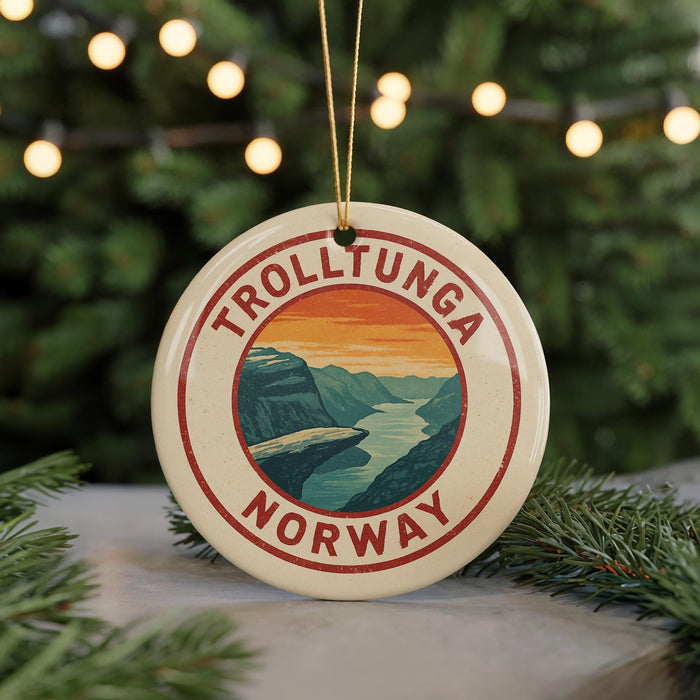 A circular ornament with the text "TROLLTUNGA NORWAY" and an illustration of a mountain landscape.