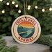 A circular ornament with the text "TROLLTUNGA NORWAY" and an illustration of a mountain landscape.