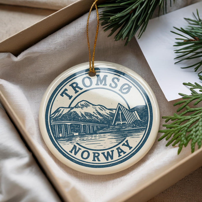 A circular ornament with the text "TROMSO NORWAY" printed on it, hanging from a string.
