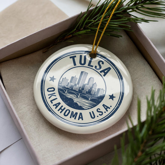 A circular ornament with the text "TULSA OKLAHOMA U.S.A." printed on it, surrounded by pine branches.
