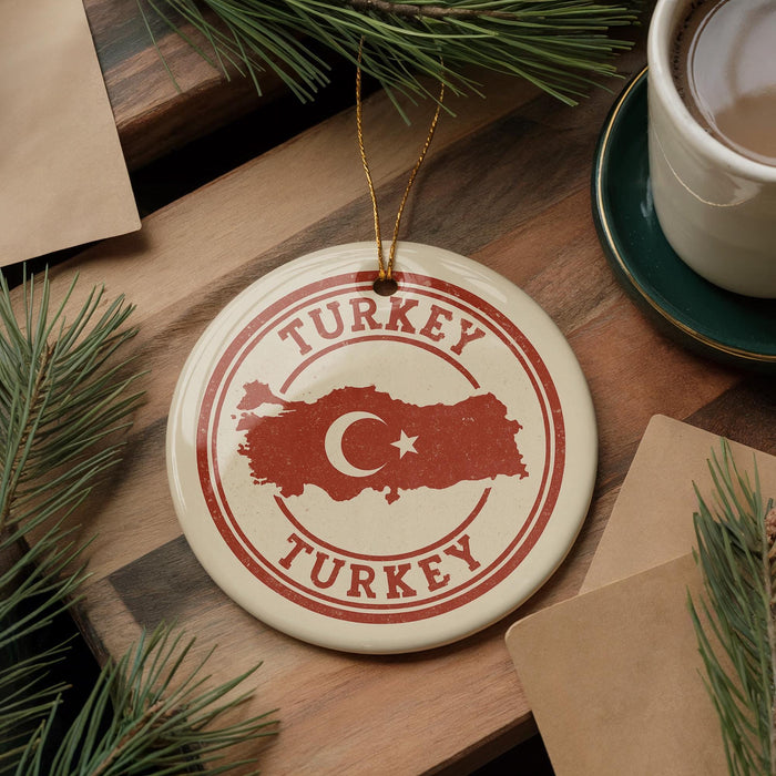 A circular ornament with the word "TURKEY" and a map of Turkey, along with a crescent moon and star, is displayed on a wooden surface.