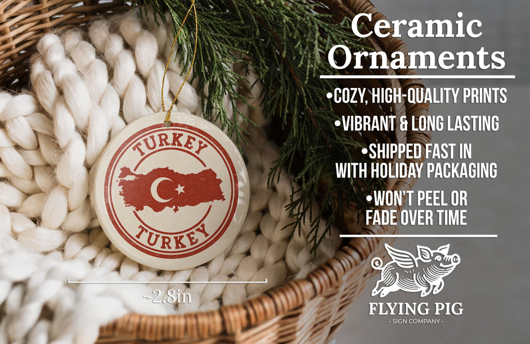 Ceramic ornaments, including a Turkey ornaments, are displayed in a basket with a pine branch.