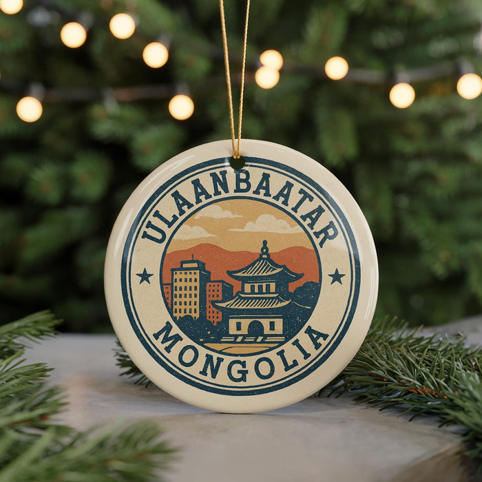 A circular ornament with the text "ULAANBAATAR MONGOLIA" and an illustration of a building and mountains, hanging from a string.