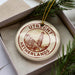 A circular ornament with the text "UTRECHT NETHERLANDS" printed on it, surrounded by pine branches.