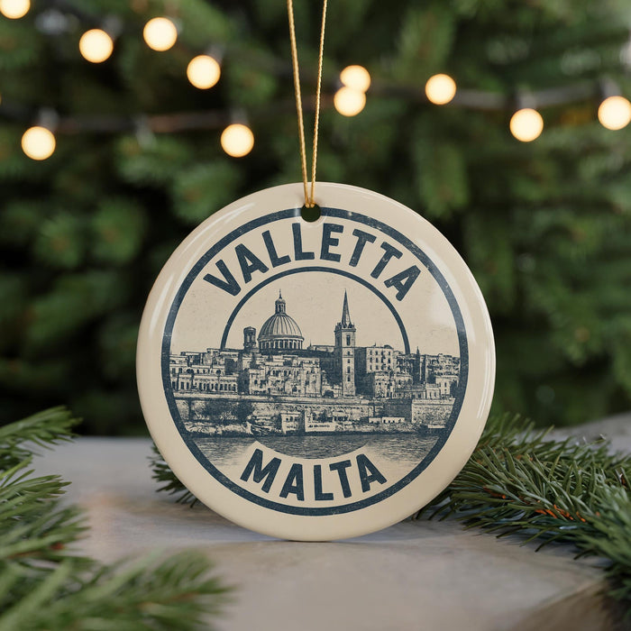A circular ornament with the text "VALLETA MALTA" and an illustration of a cityscape, hanging from a string.
