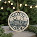 A circular ornament with the text "VALLETA MALTA" and an illustration of a cityscape, hanging from a string.