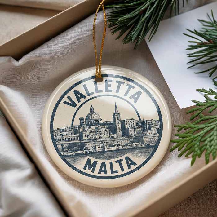 A circular ornament with the text "VALLETA MALTA" printed on it, featuring an illustration of a cityscape.
