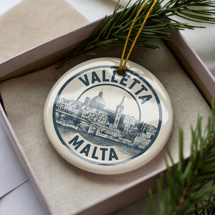 A circular ornament with the text "VALLETA MALTA" printed on it, surrounded by a decorative border.