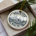 A circular ornament with the text "VALLETA MALTA" printed on it, surrounded by a decorative border.