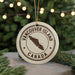 A white ornament with the text "VANCOUVER ISLAND CANADA" printed on it, featuring a map of Canada.