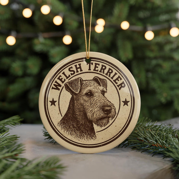A circular ornament featuring a Welsh Terrier dog's head, with the text "WELSH TERRIER" printed on it.