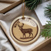 A round ornament with a deer image and the text "WHITE TAILED DEER" is displayed in a box with pine branches.